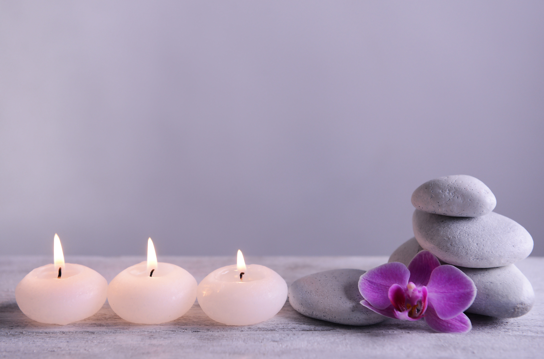 White Spa Stones with Candles on Gray Background